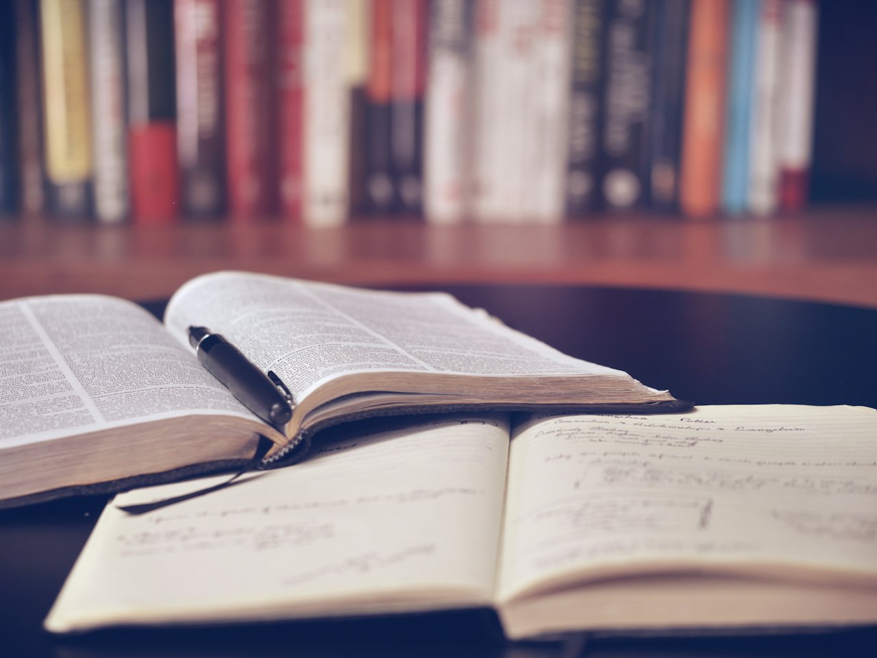 Open books and notes on a library table
