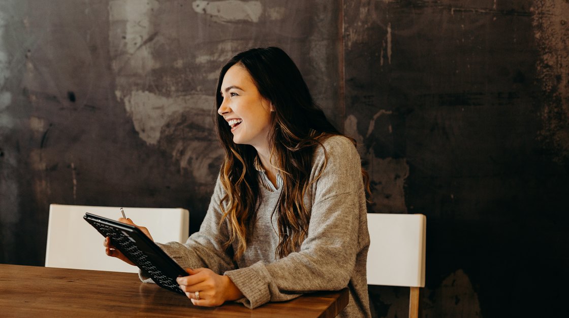 Woman smiling during a conversation in a café