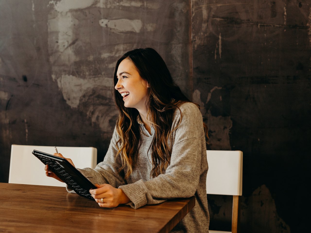 Woman smiling during a conversation in a café