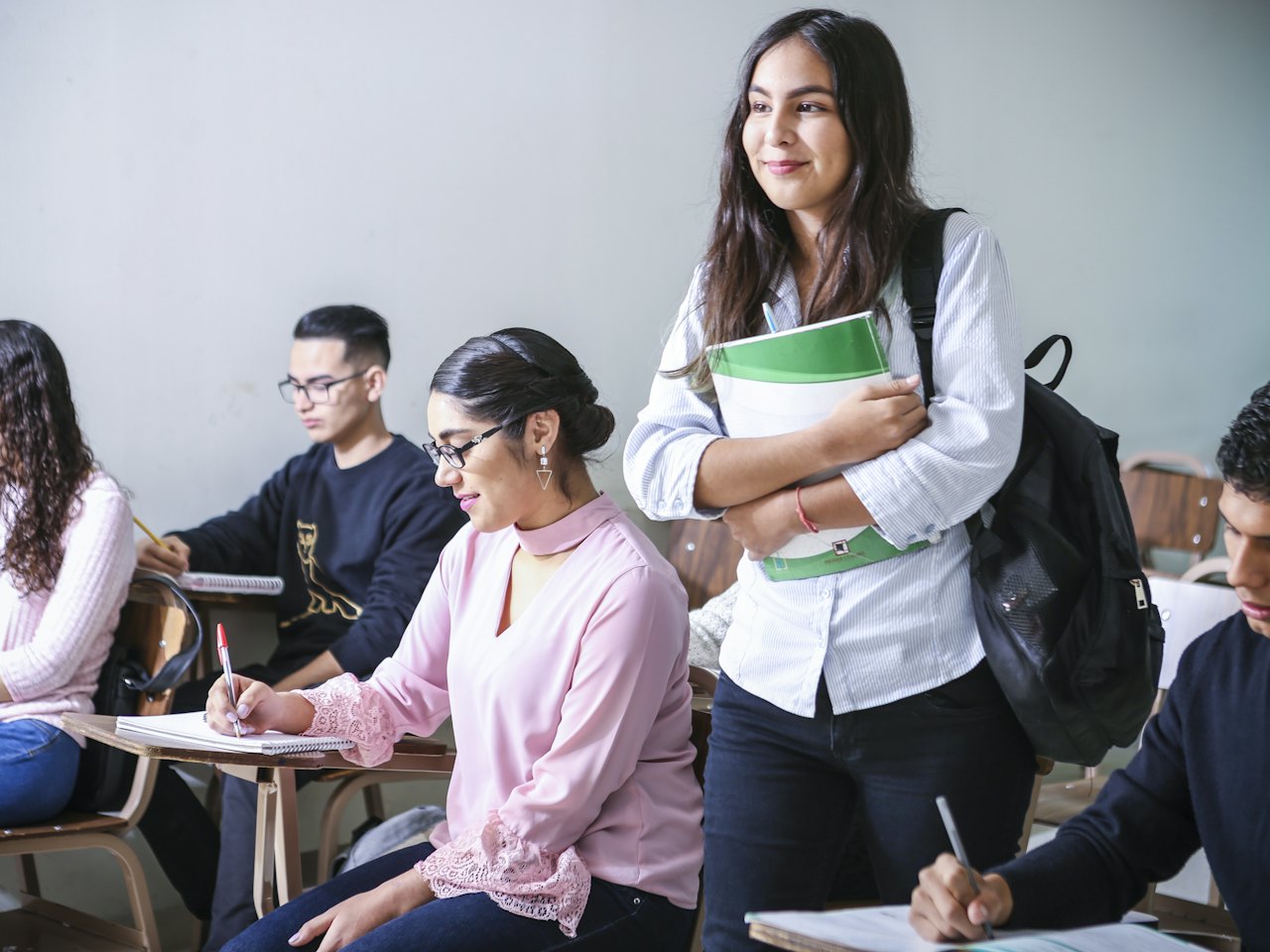 Adult students taking notes in a classroom