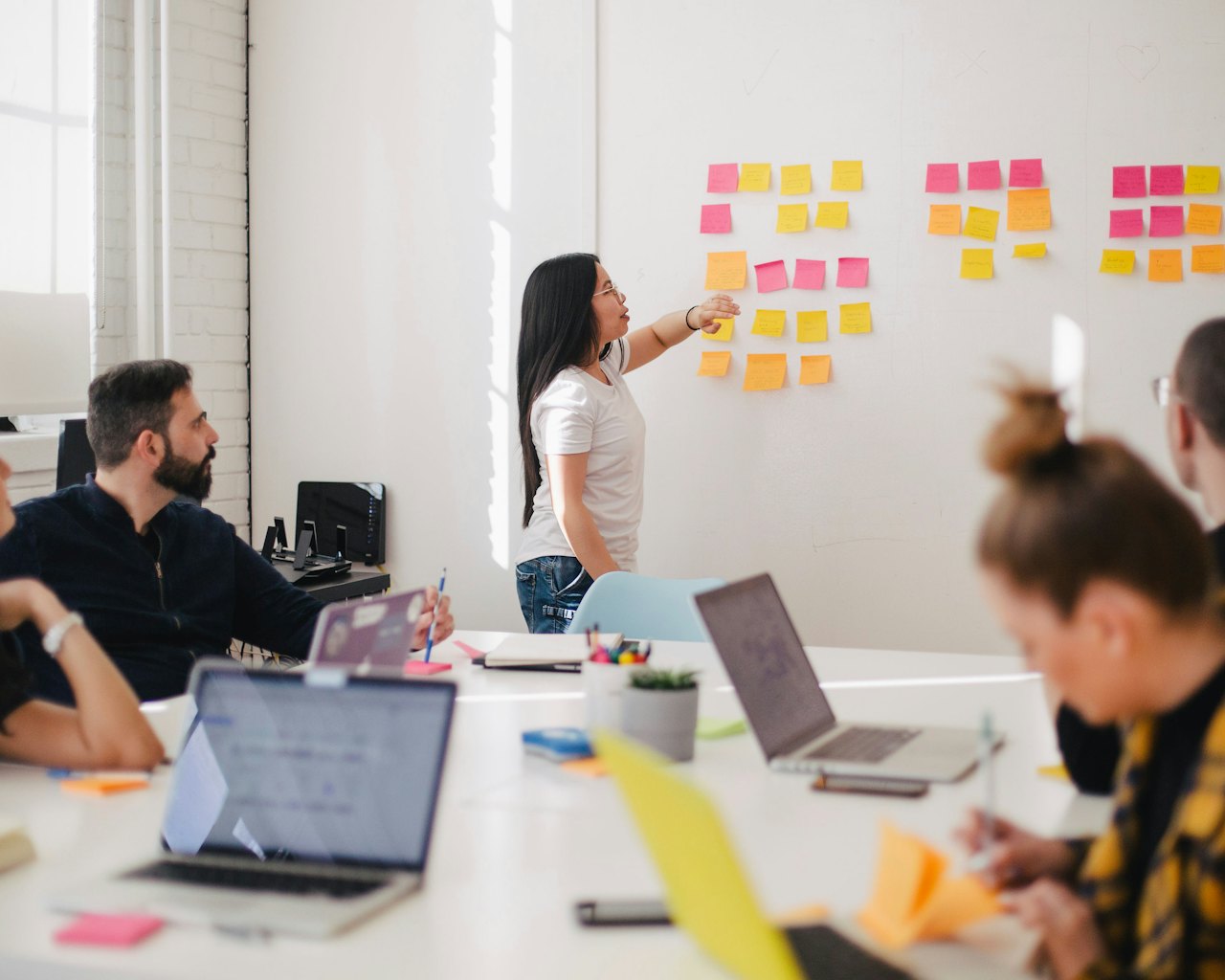 Group working with sticky notes on a whiteboard in a classroom